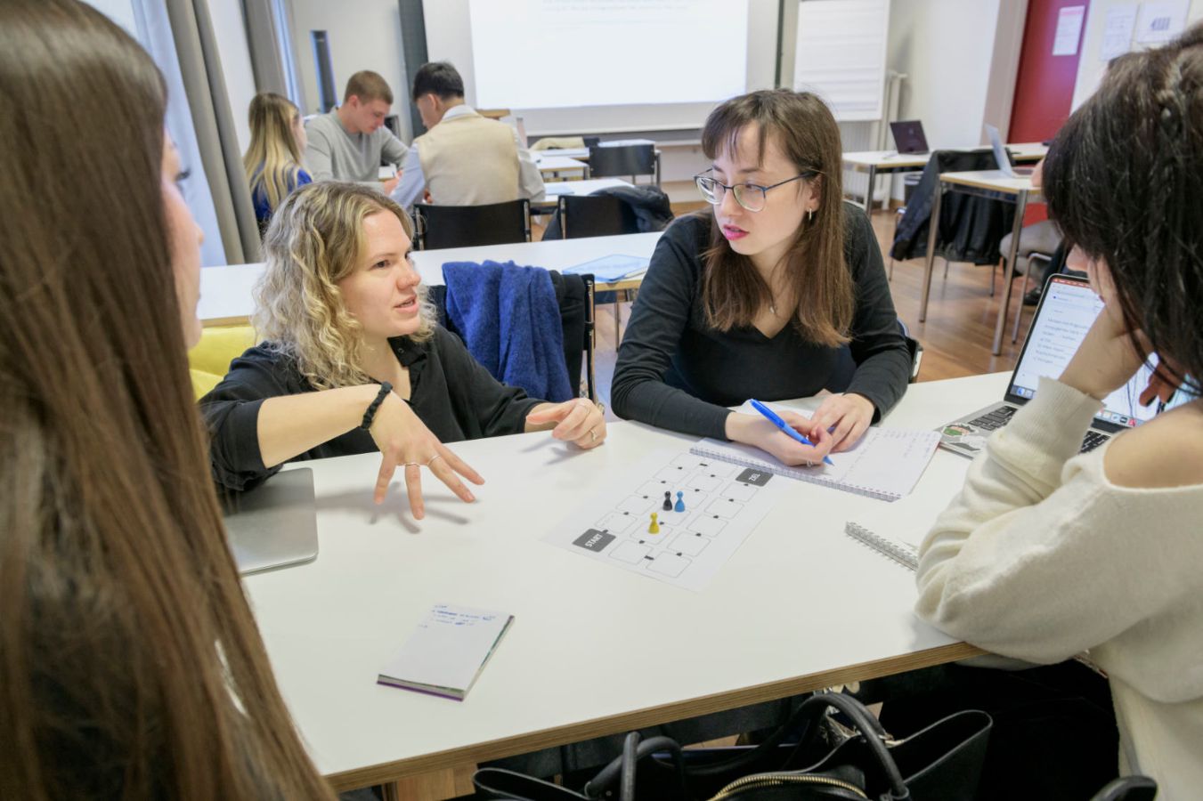 Creative exam preparation: Corinna Viviani, a German as a foreign language teacher, explains the rules of the game to Snizhana (right) and her study group.